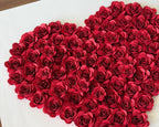 Handmade paper roses arranged into a heart before framing