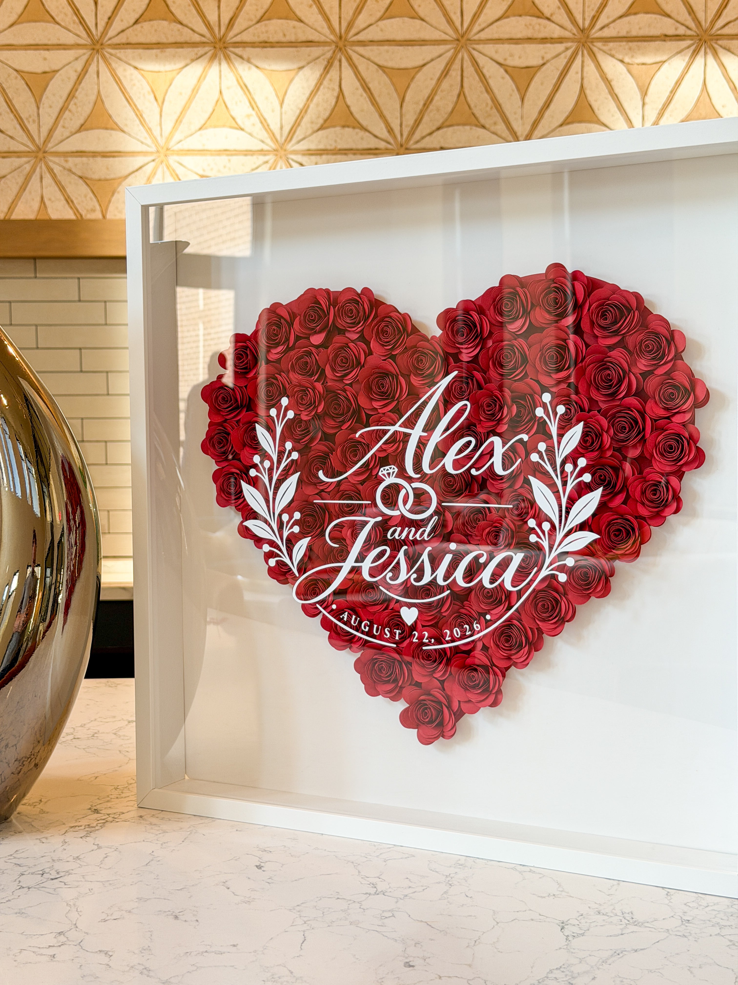 Wedding flower frame with names and date lettered in white on the glass