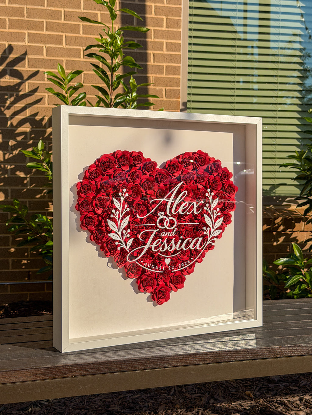Wedding flower frame in the sun, showing the depth and shadow of the paper roses